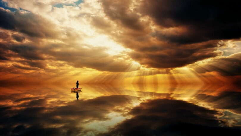 Image of a person fishing in the middle of a silent ocean