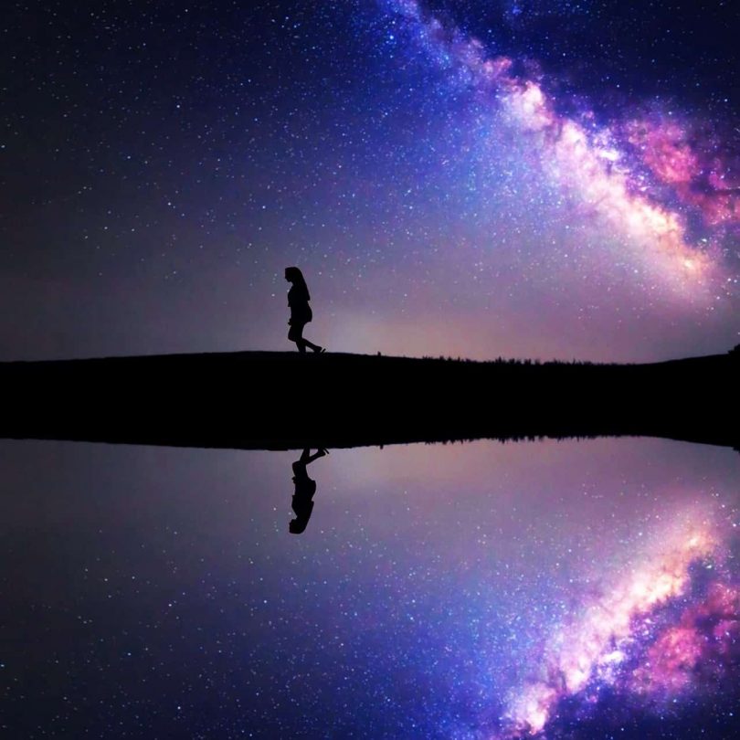 Image of a woman walking under the stars on her spiritual awakening process path