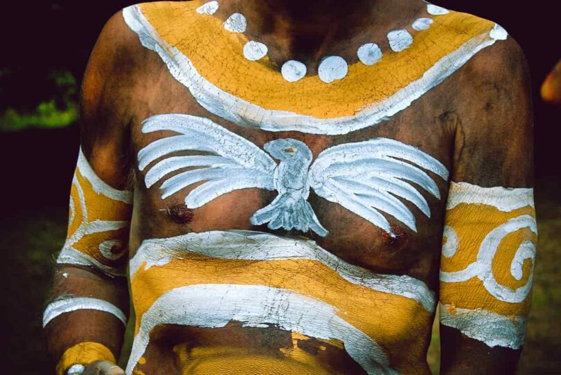 Image of a man with a spirit animal painted on his chest