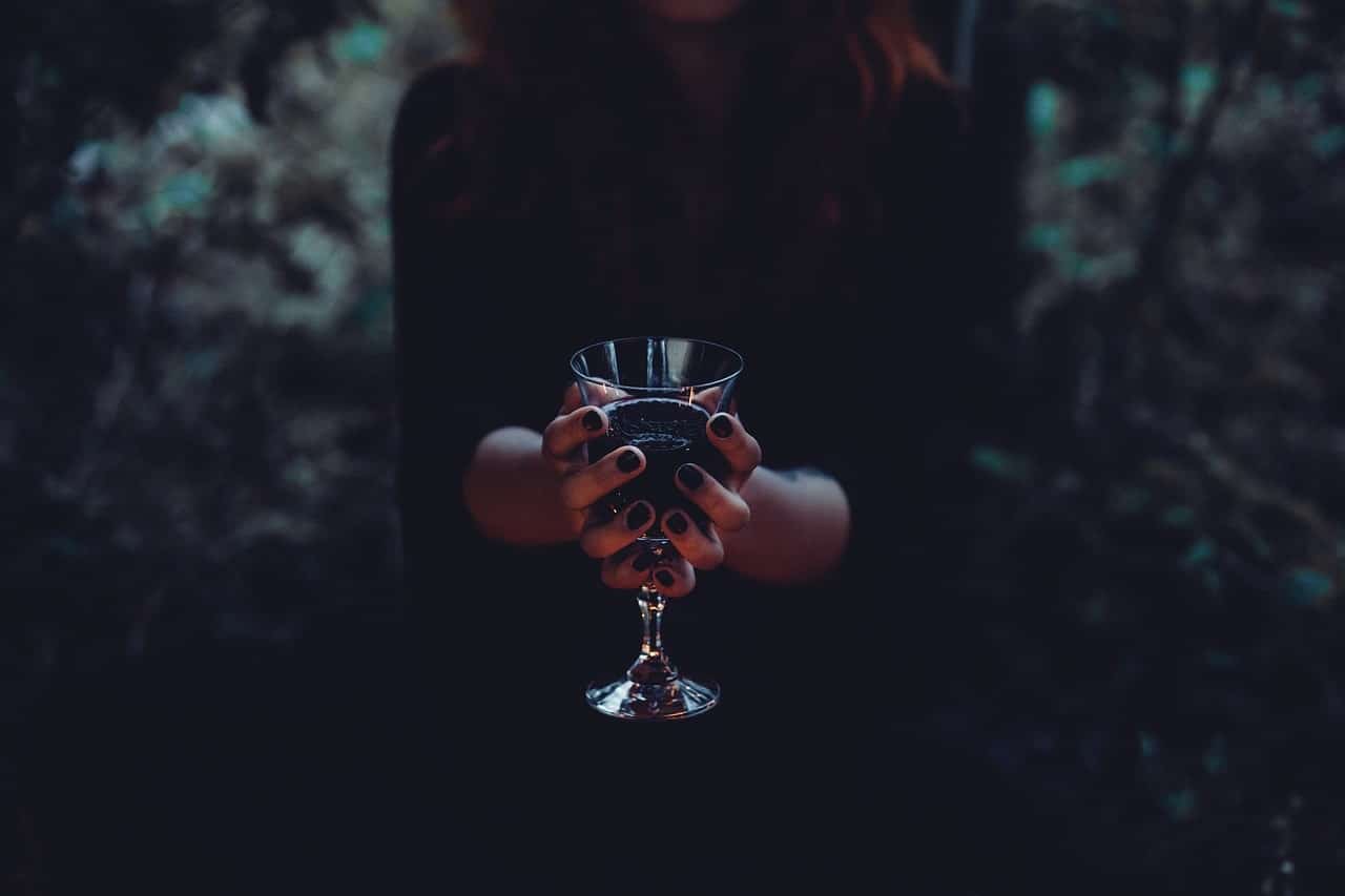 image of a gothic woman holding a cup symbolizing shadow work