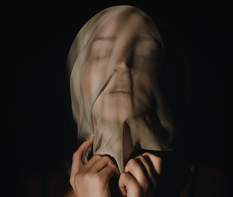 Image of a woman with a veil over her face