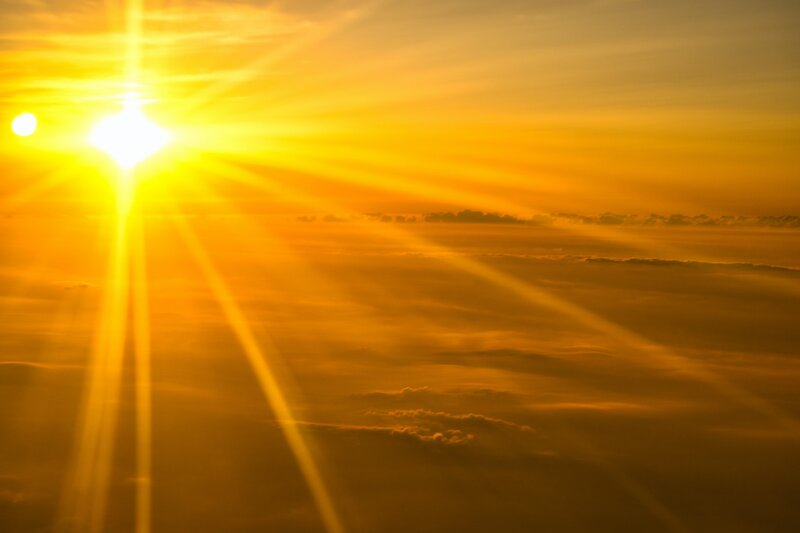 Image of enchanting yellow sunshine above the clouds