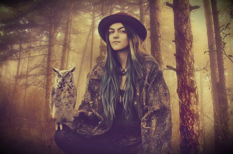 Image of an old soul woman in a forest holding an owl