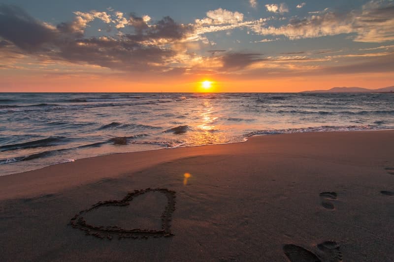 Image of a heart drawn on the sand of a beautiful beach