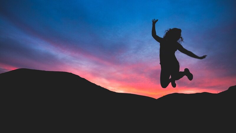 Image of a happy and joyous woman jumping