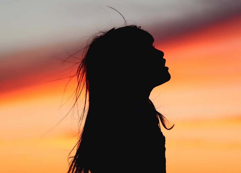 Image of a woman looking up at the sky