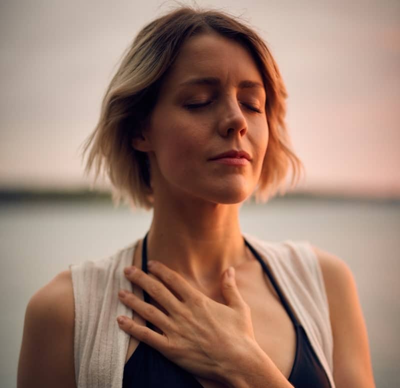 Image of a woman feeling happy and showing self-love