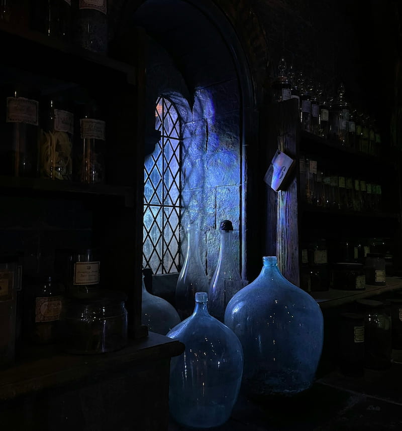 Image of some alchemical vessels sitting in front of a mysterious window