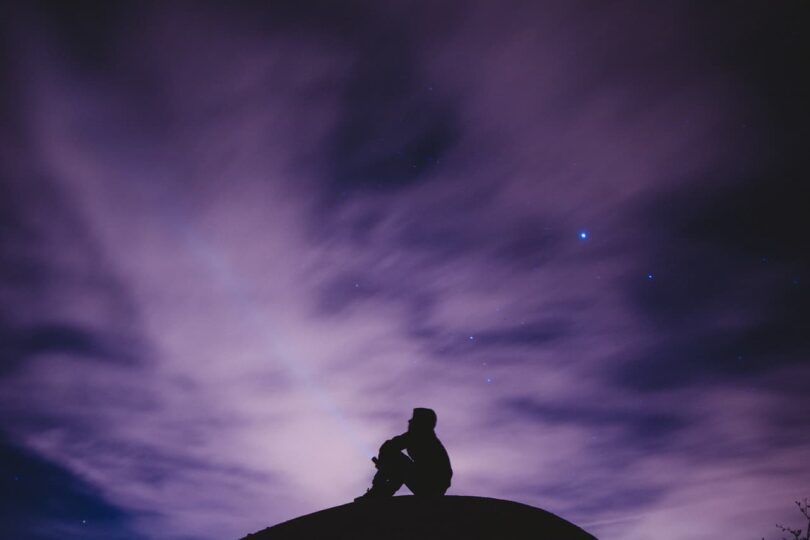 Image of a sad and lonely man looking at the sky