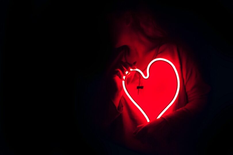 Image of a person holding a red electric heart