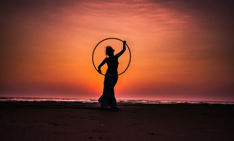 Image of a woman on the beach at sunset symbolic of the higher self