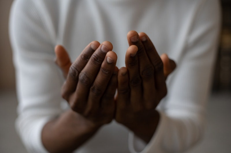 Image of a person cupping their hands in prayer