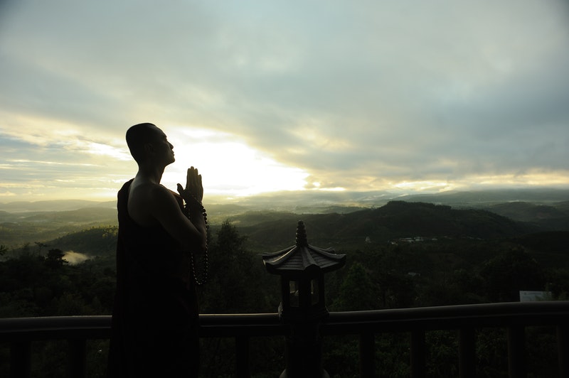 Image of a monk demonstrating the power of prayer