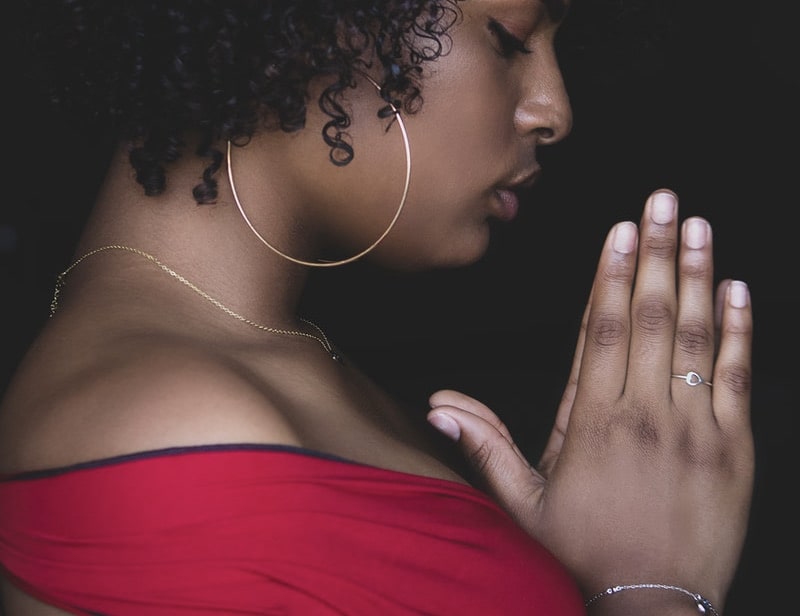 Image of a woman deep in prayer