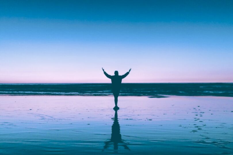 Image of a person raising up their hands and demonstrating the power of prayer