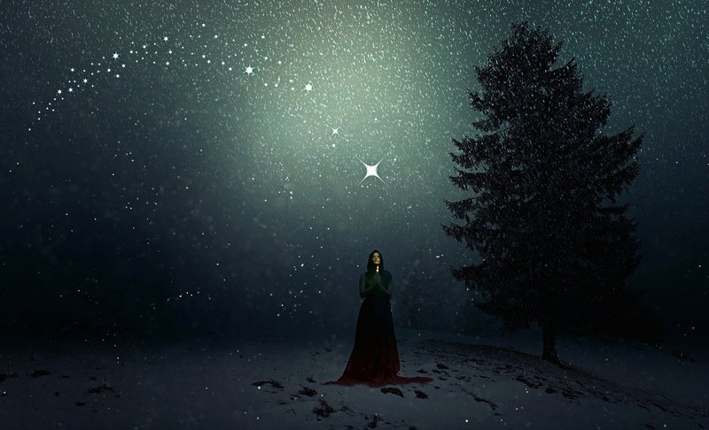 Image of a woman in the snow at night with a star omen above her head