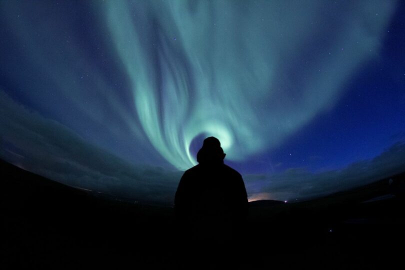 Image of a man watching the aurora borealis symbolic of doing inner work