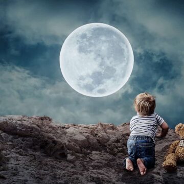 Image of a little boy looking at the moon symbolic of inner child work