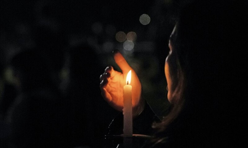 Image of a woman holding a candle