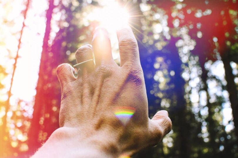 Image of a man reaching for the sun symbolic of soul communication