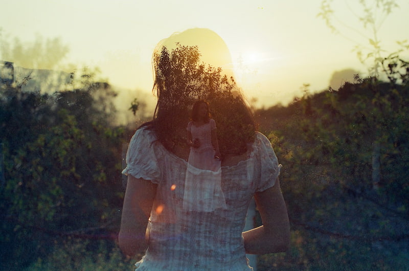 Double exposure image of a woman suffering from soul loss and seeking ensoulment