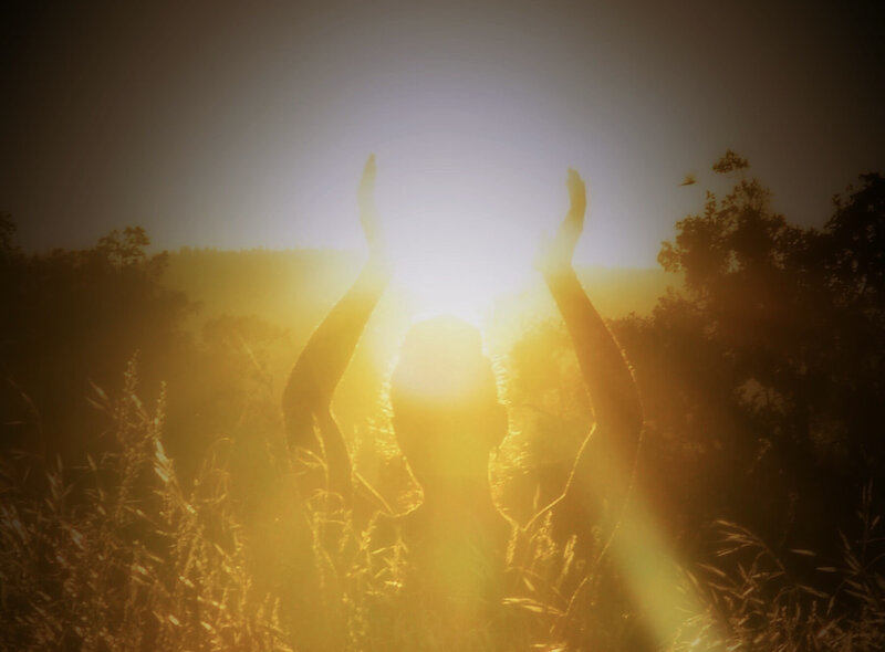 Image of a woman standing in yellow sunlight