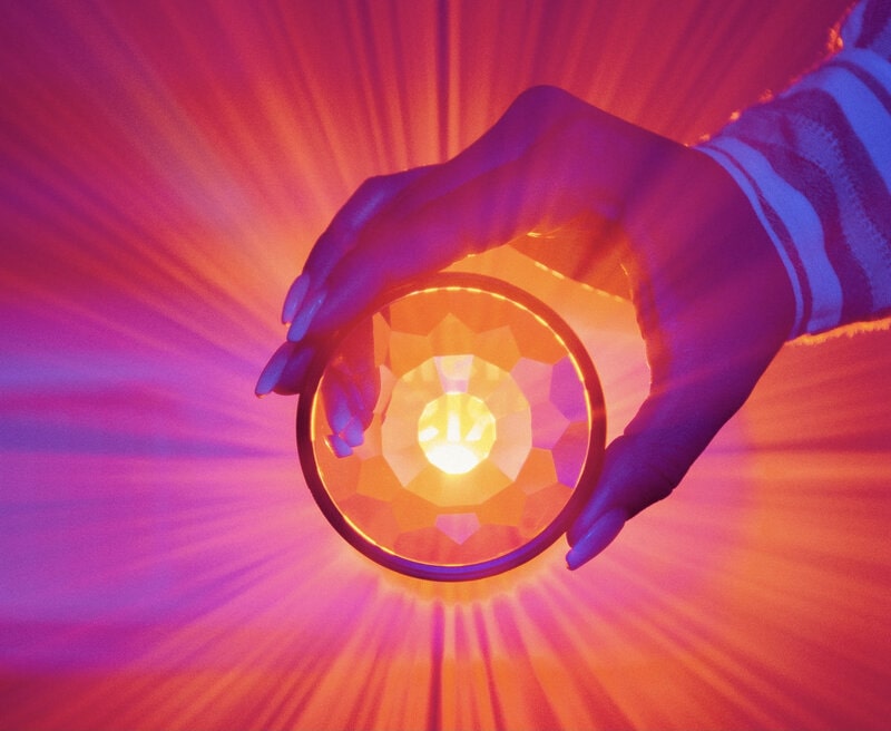 Image of bright pink light coming through a crystal globe