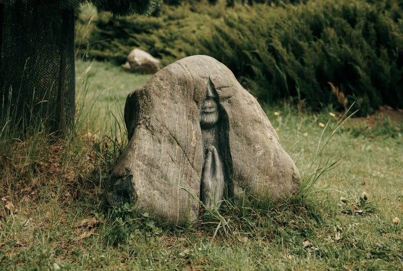 Image of a rock carved with an image of a person praying