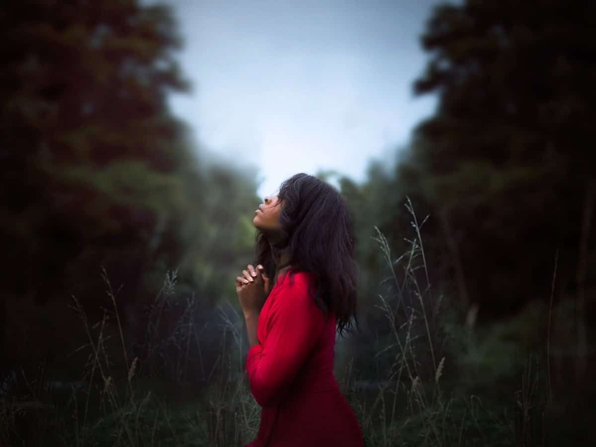 Image of a woman praying and showing gratitude