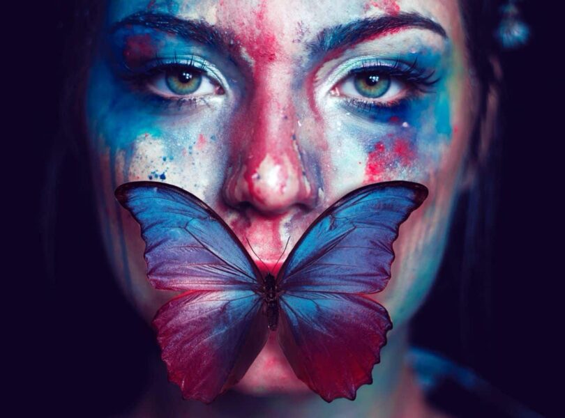 Image of a woman with a butterfly on her face symbolizing inner strength