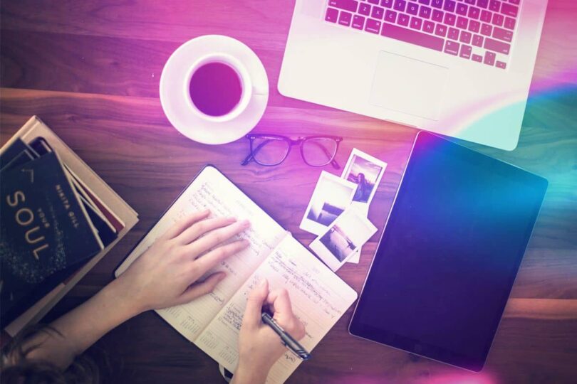 Image of a woman journalling on her desk