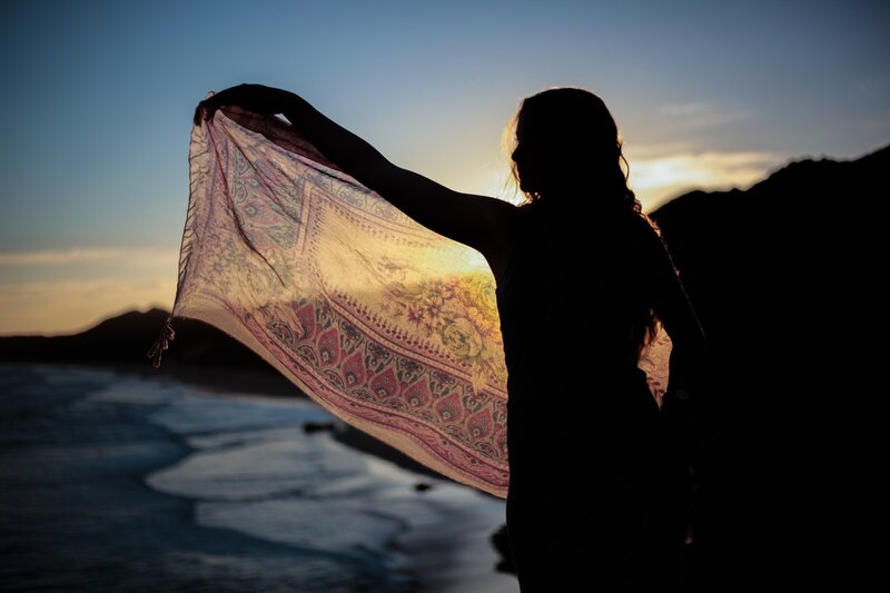 Image of a woman waving a shawl in the wind