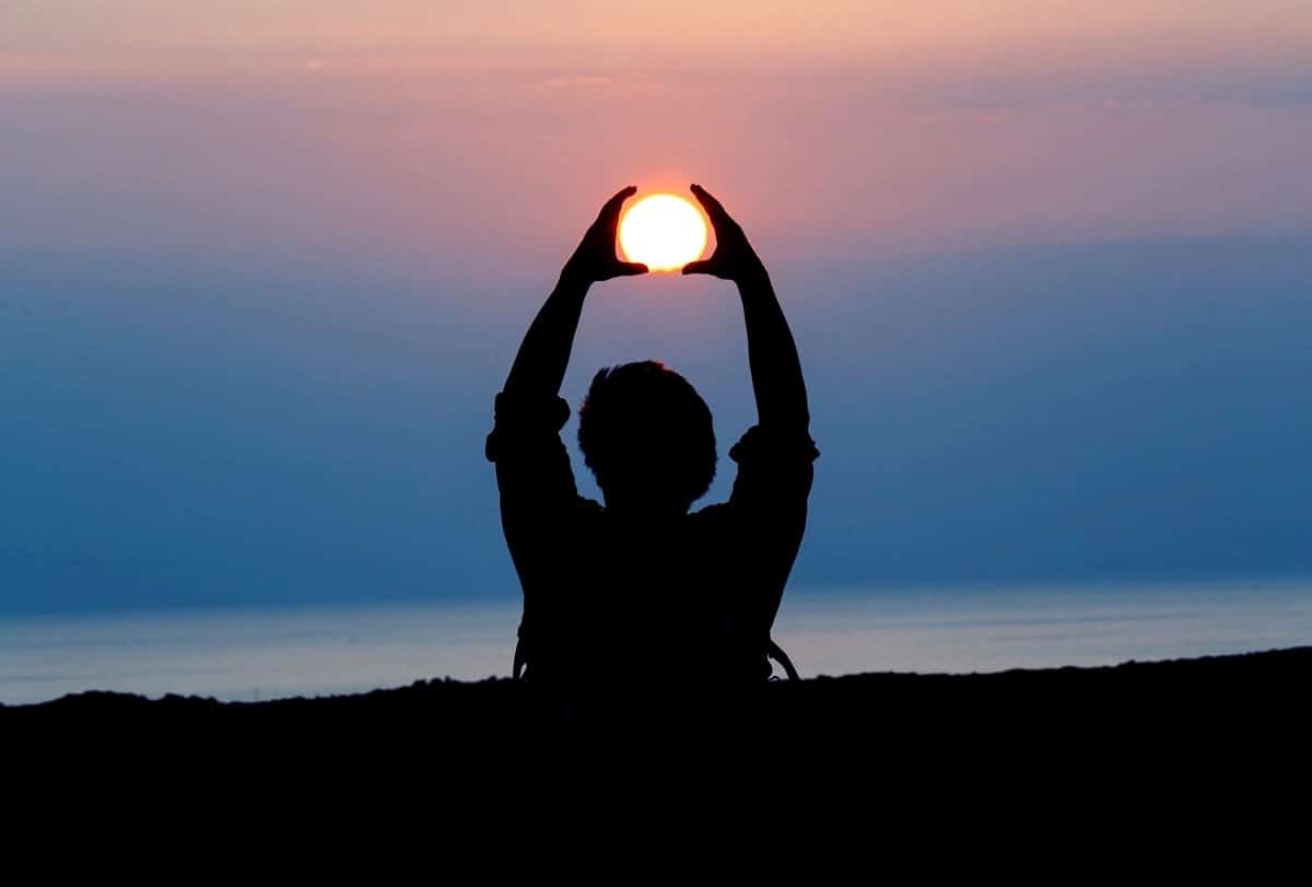 Image of a man and the sun setting symbolizing spiritual healing