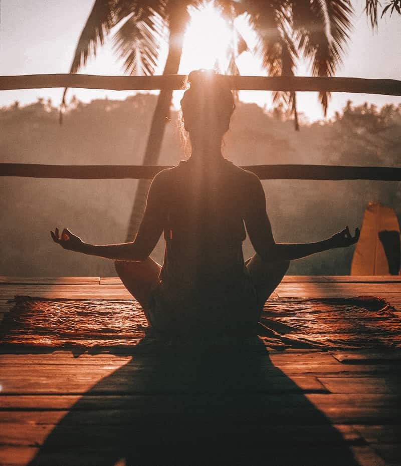 Image of a woman meditating to obtain self-awareness