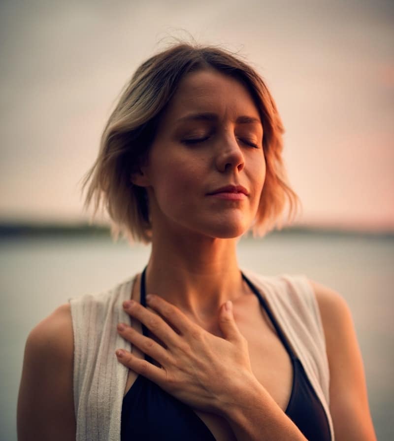 Image of a sincere woman with her hands over her heart practicing spiritual discernment