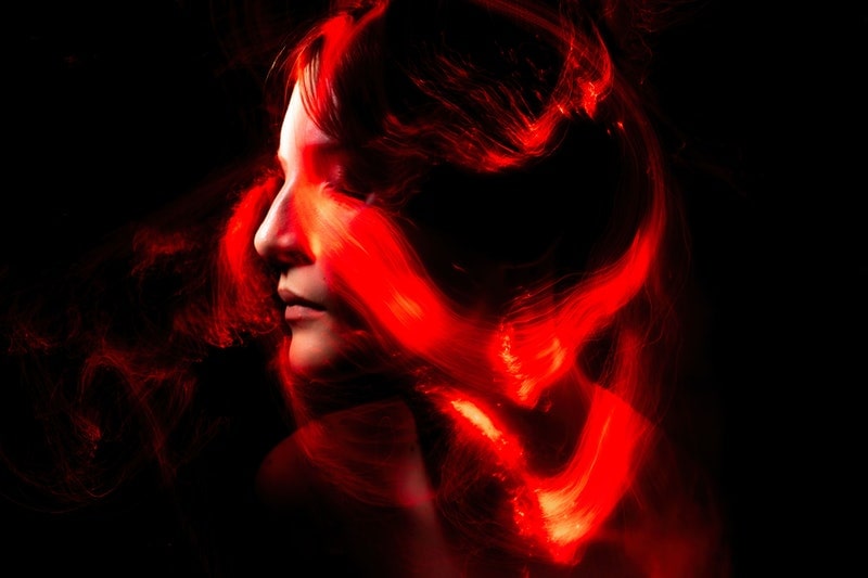 Image of a woman with red tendrils of dangerous energy around her head