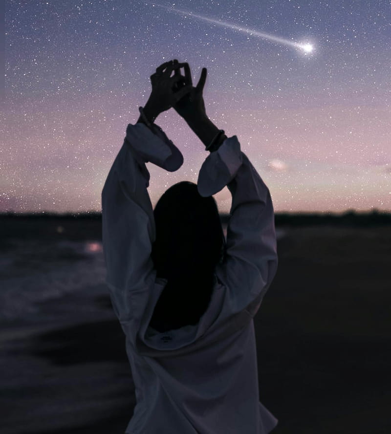 Image of a woman dancing under the stars
