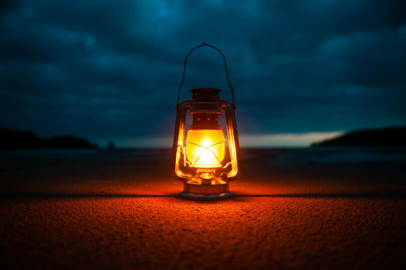 Image of a lantern in the darkness symbolic of the sacred practice of inner work and soul recovery