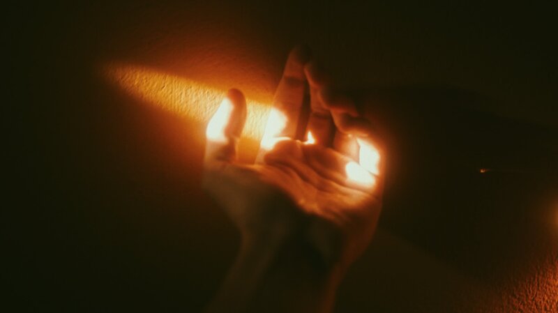 Image of a person's hand reaching for sunlight symbolic of trying to find oneself