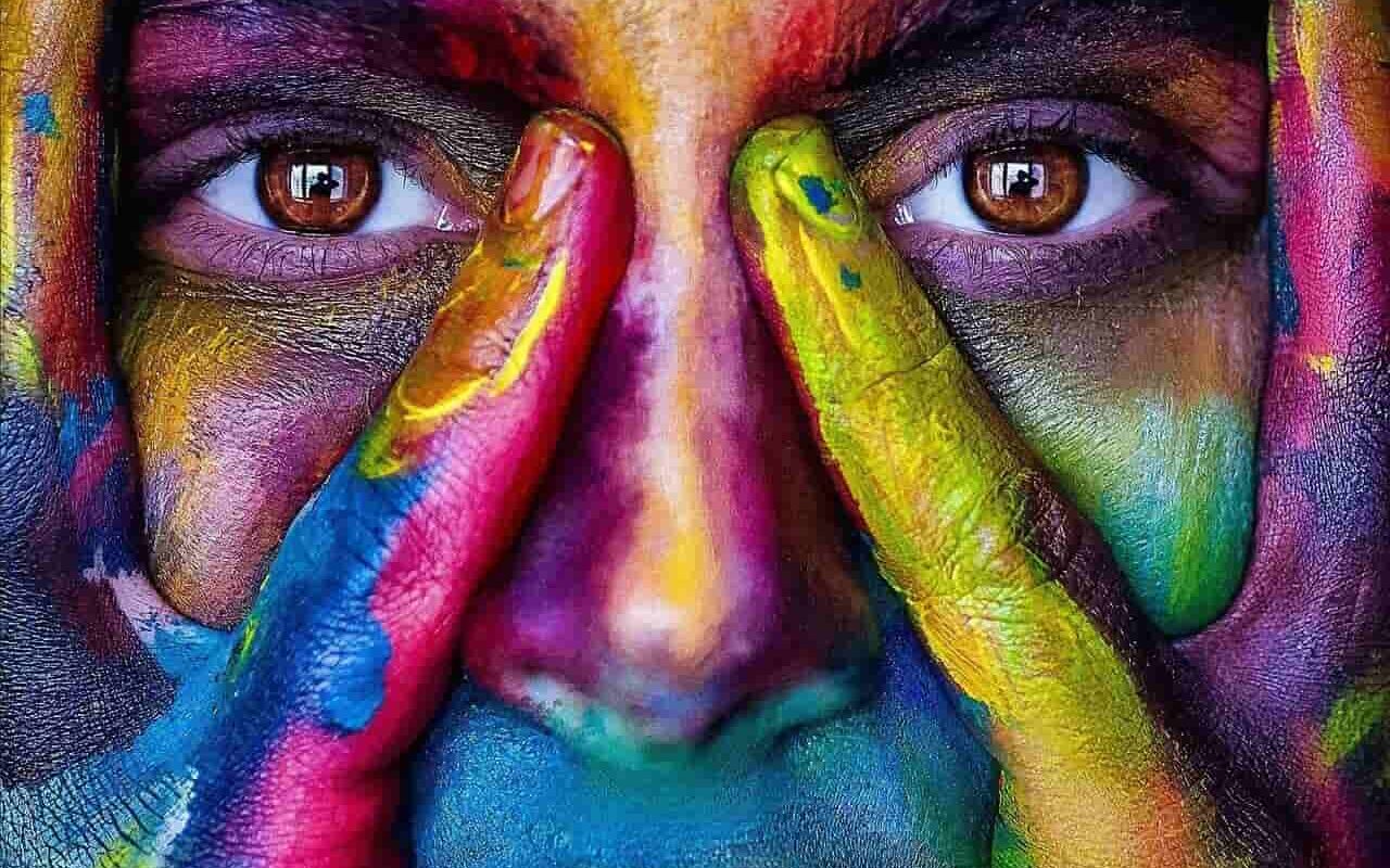 Image of an artistic colorful woman thinking of some art therapy ideas