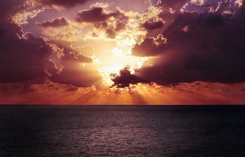 Image of a sun over the ocean symbolic of self-realization