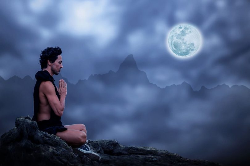 Image of a man in meditation and the moon