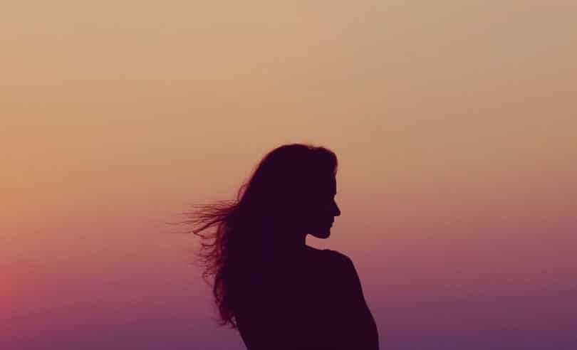 Image of a woman and the sunset soul searching