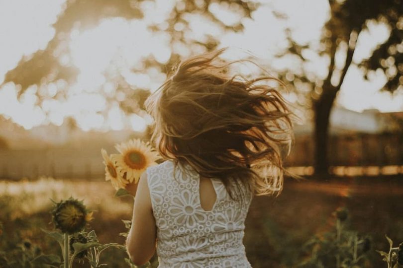 Image of the inner child running with sunflowers