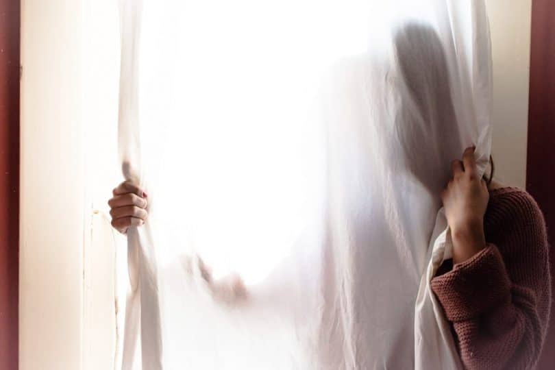 Image of a lost woman and a curtain experiencing a spiritual emergency