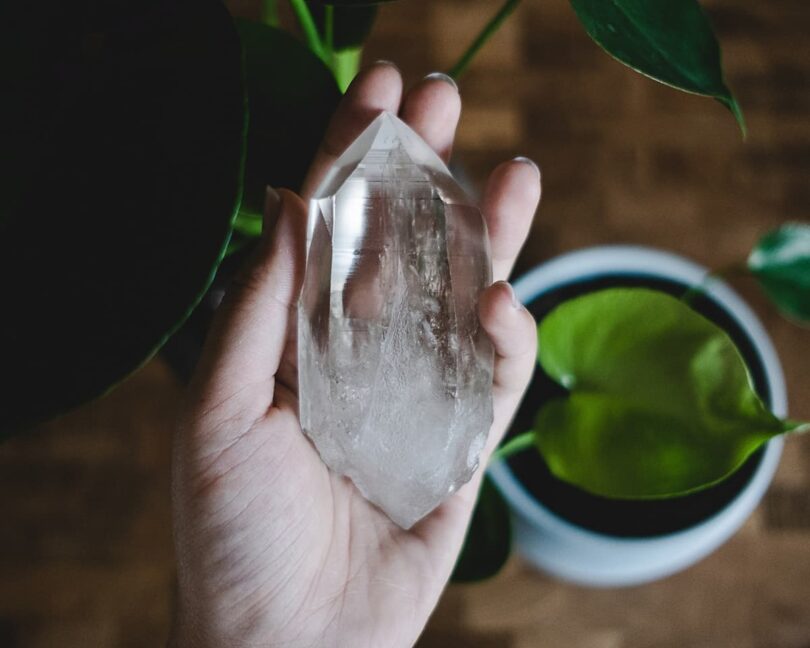 Image of a woman holding a crystal representing spiritual materialism