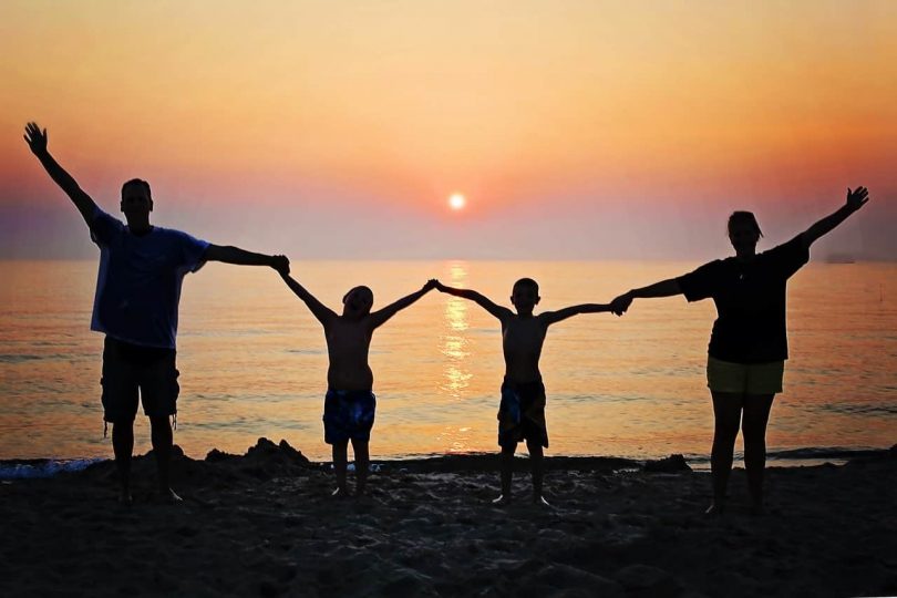 Image of a happy family at the beach