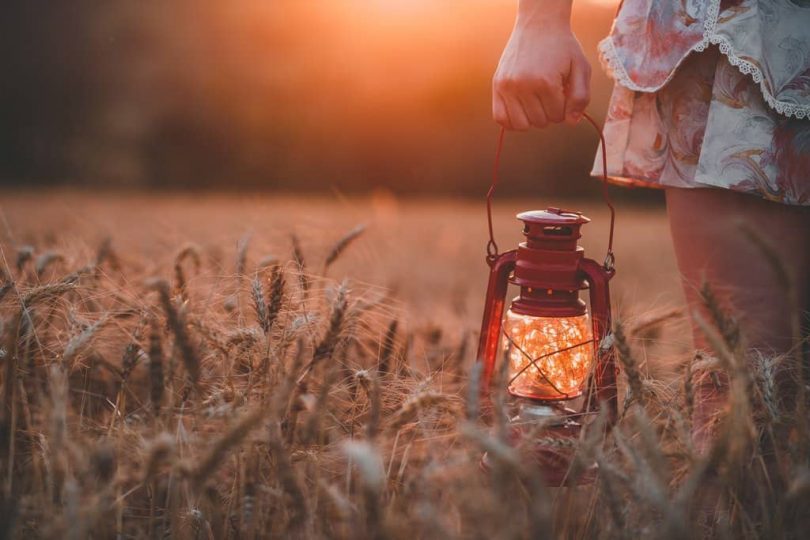 Image of a woman holding a lamp that symbolizes how to trust your intuition