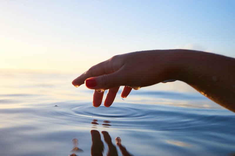 Image of a person touching calm water