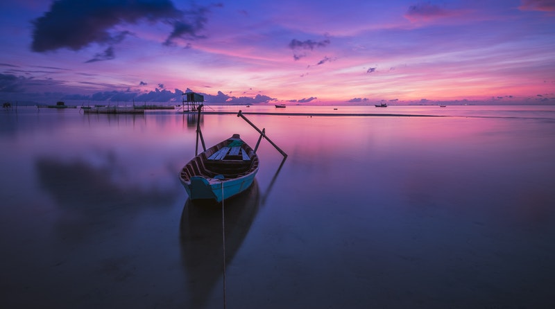 Image of a boat on a calm ocean that represents inner peace